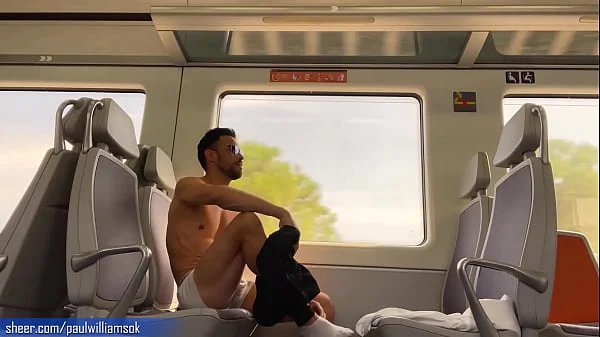 Sexy tanned man travelling naked by train. Very risky public nudity