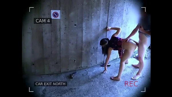 Young couple fucks in front of the garage exit and is caught by the surveillance camera